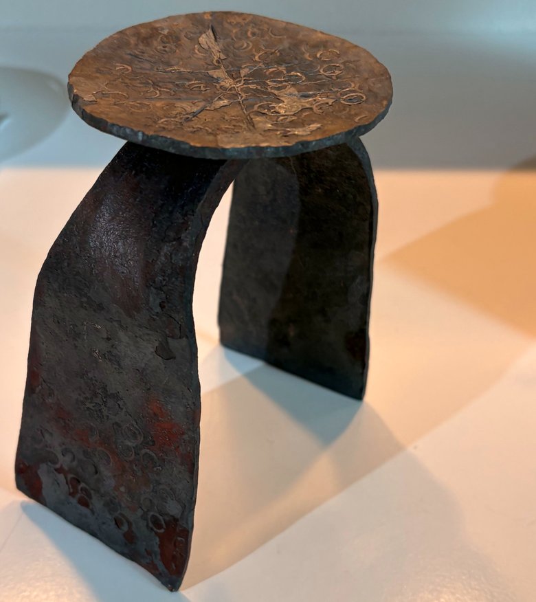 Forged steel sculpture: an arched form with a textured disc top, hammered and surface-treated. Personal hobby project.